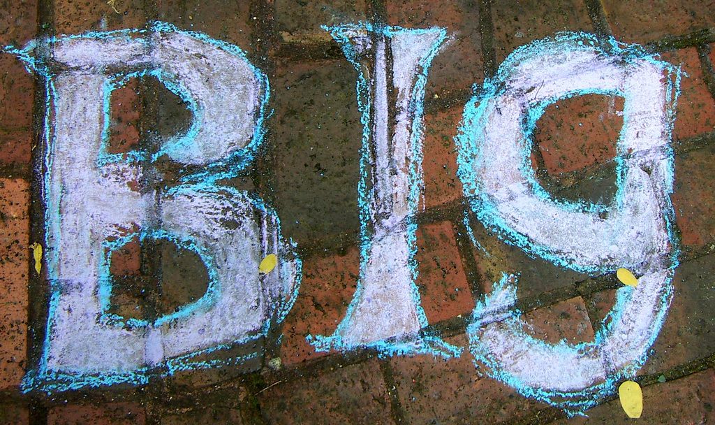 The word "big" chalked onto bricks